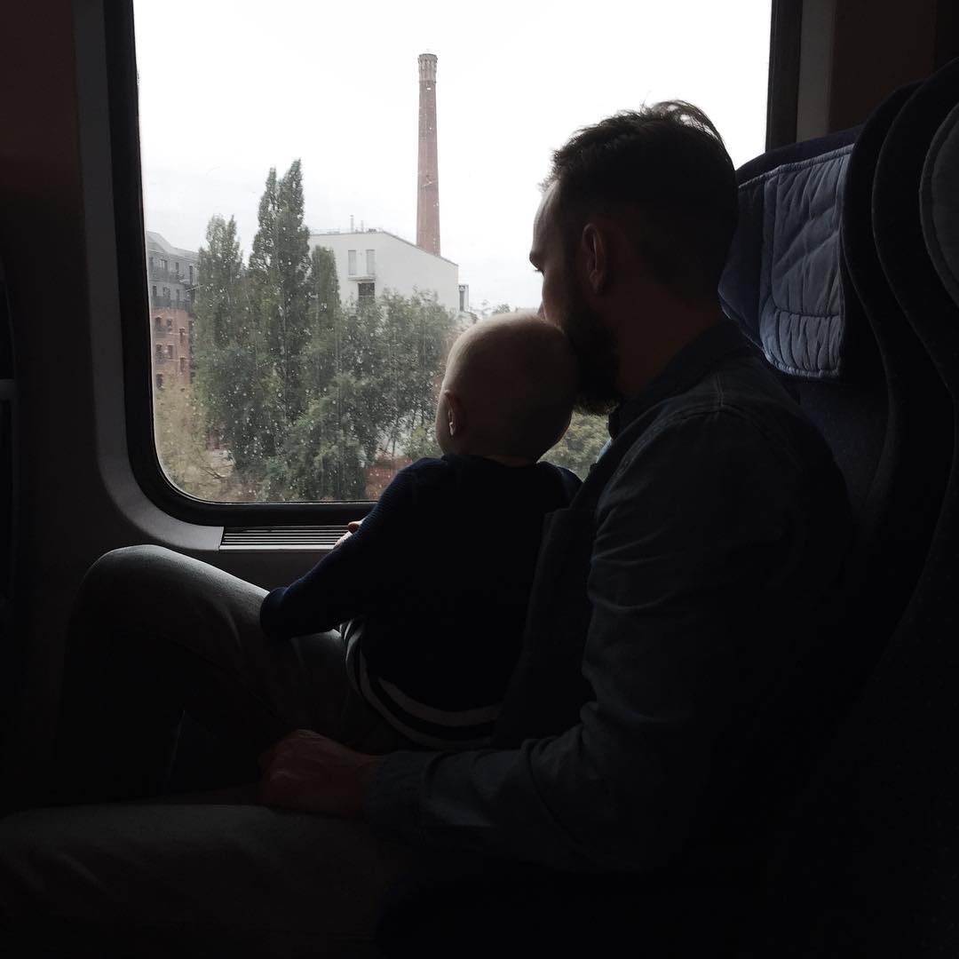 Roel van der Ven with his son on his lap looking out the train